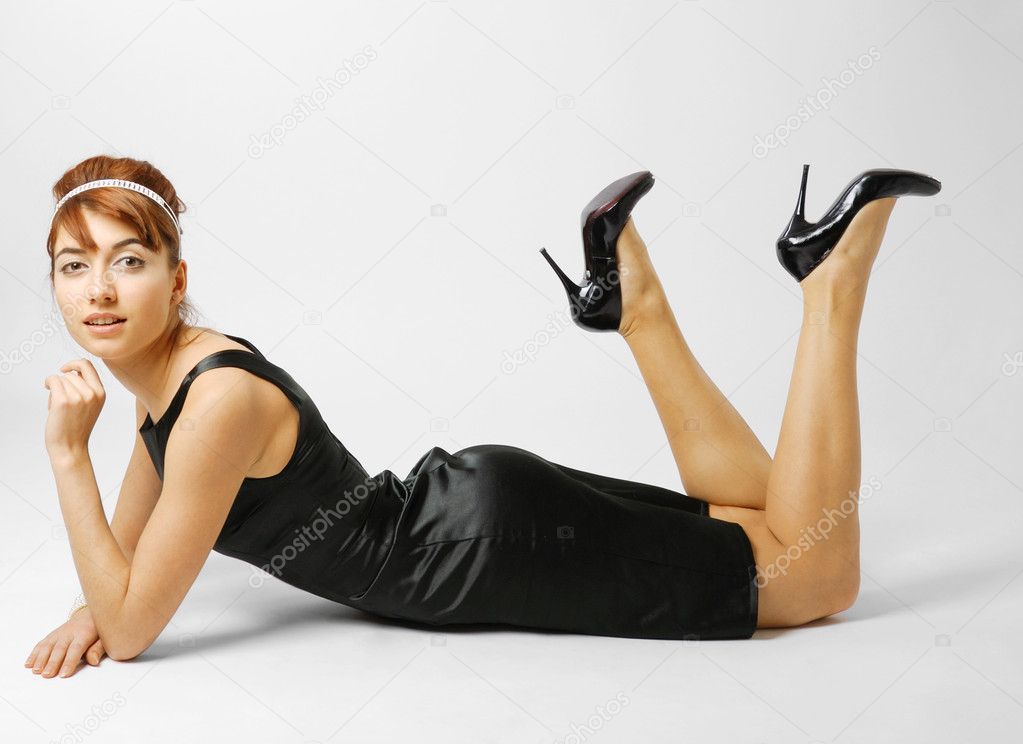 Woman lying in black shoes heeled