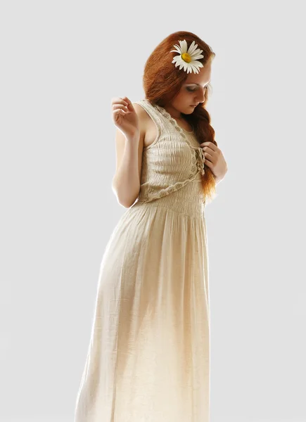 Girl in sundress with daisy in red hair — Stock Photo, Image