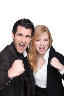 Business couple with their fists in the air clipart