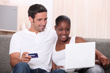 Couple shopping on the internet clipart