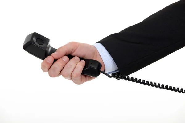 Przycięte zdjęcie biznesmen posiadania telefonu stacjonarnego. — Zdjęcie stockowe
