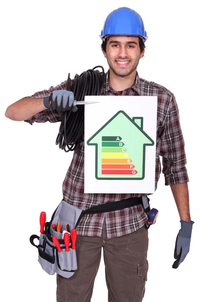 Electrician holding energy information board — Stock Photo, Image