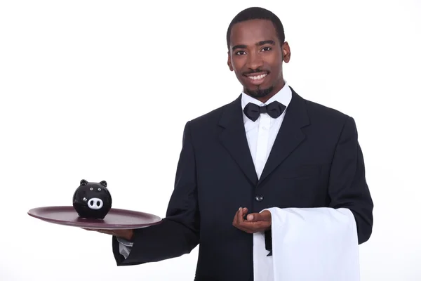 Waiter with piggy bank — Stock Photo, Image