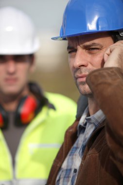 Construction worker on the phone clipart