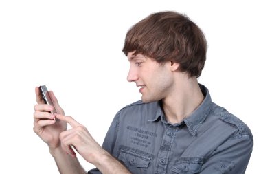 Young man taping on his cell phone clipart