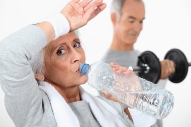 Elderly couple working out together clipart