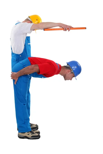 Two carpenters forming the letter F — Stock Photo, Image