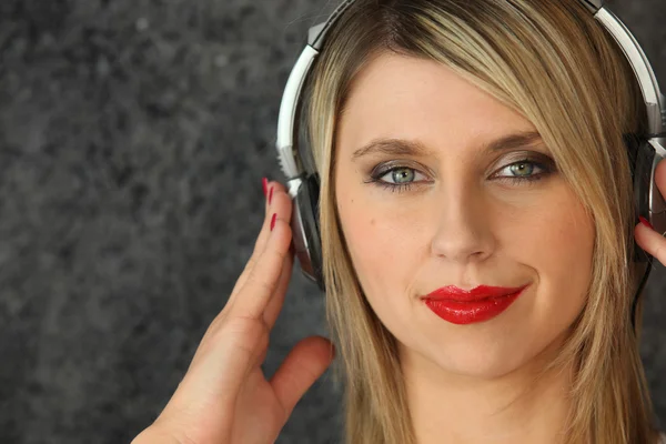 Blond woman with old-style headphones — Stock Photo, Image