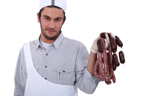Butcher holding sausages — Stock Photo, Image