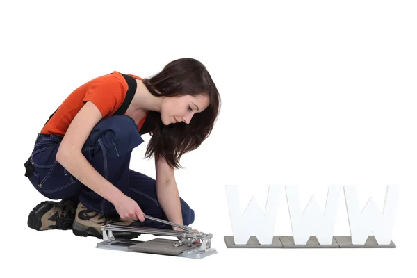 Woman using a manual tile cutter — Stock Photo, Image