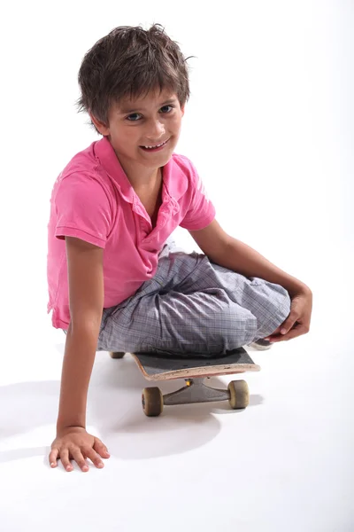 Menino sentou-se no skate — Fotografia de Stock
