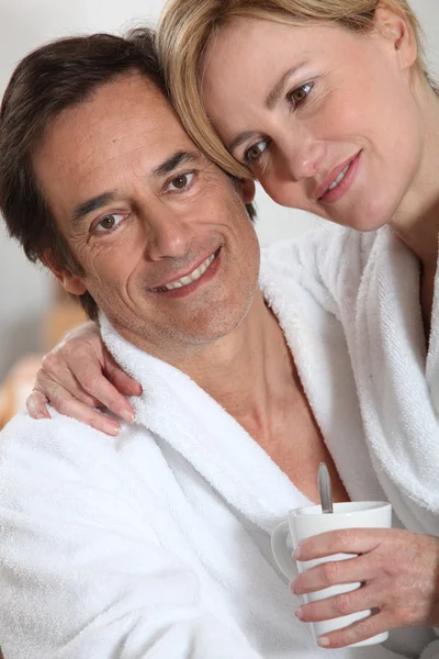 Couple dressed in bath robes — Stock Photo, Image