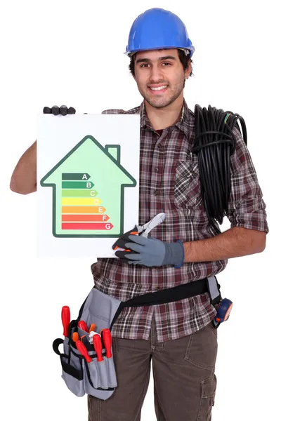 Electrician showing energy rating sign — Stock Photo, Image