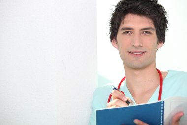 Young doctor writing in notebook clipart