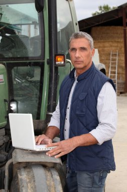 Farmer working in the computer clipart