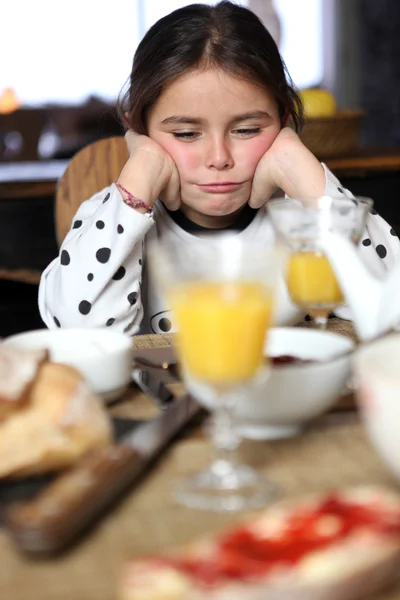 Grumpy girl at breakfast — Stock Photo, Image