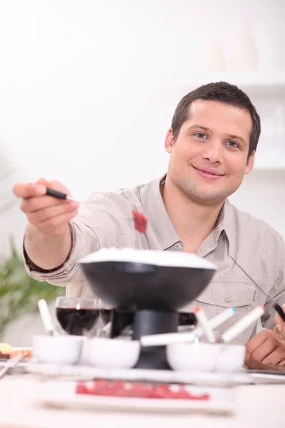 Man with fondue — Stock Photo, Image