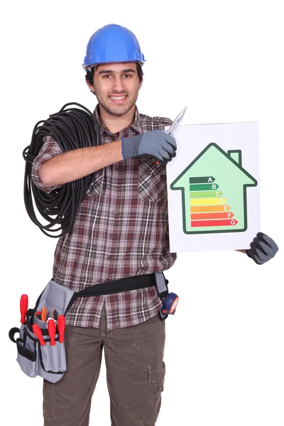 Craftsman holding an energy consumption label — Stock Photo, Image