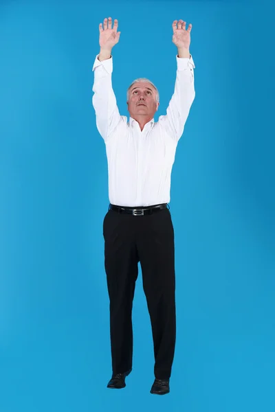 stock image Man reaching for the sky