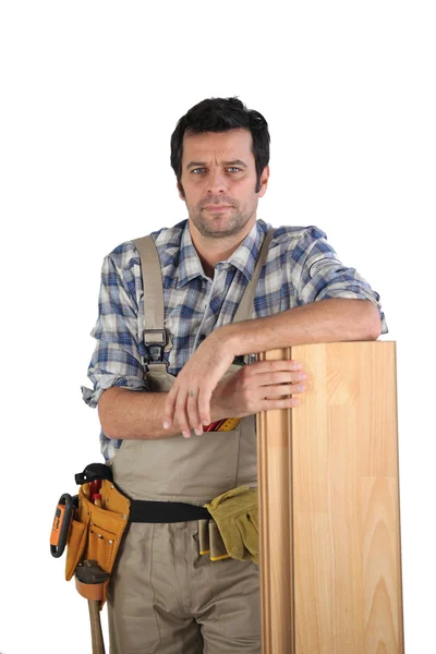 stock image Man stood with laminate floor panels