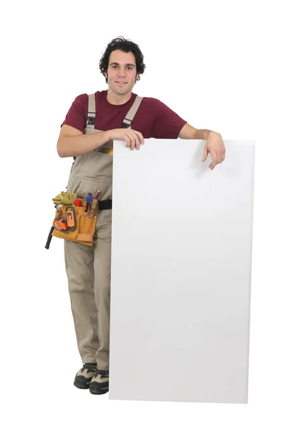 Handyman segurando placa branca — Fotografia de Stock