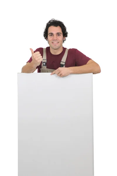 Worker holding up a blank sign — Stock Photo, Image