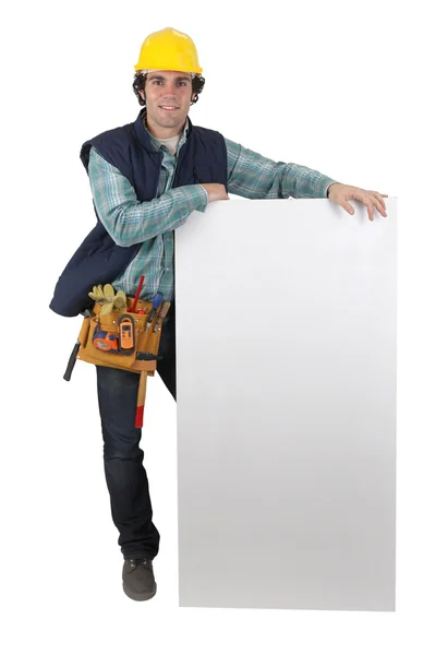 Carpenter stood with blank marketing panel — Stock Photo, Image