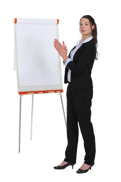 Brunette businesswoman stood by flip-chart — Stock Photo, Image