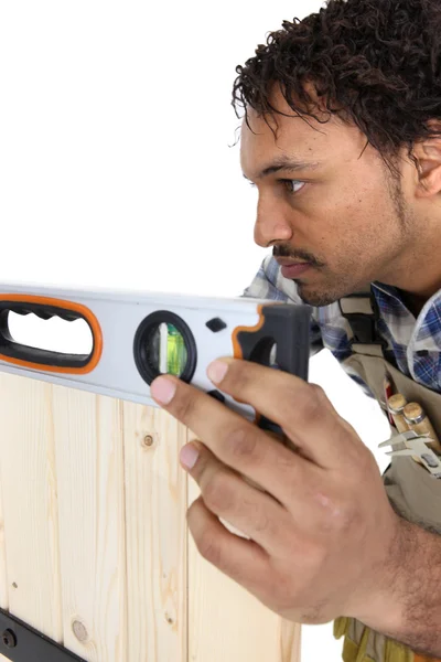 Craftsman working with level — Stockfoto