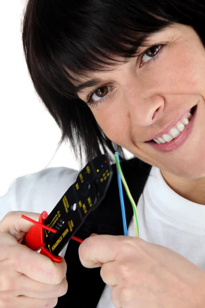 Woman cutting wire with special tool — Stock Photo, Image