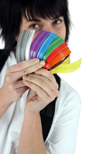 Female electrician holding much-colored cable ties — Stock Photo, Image