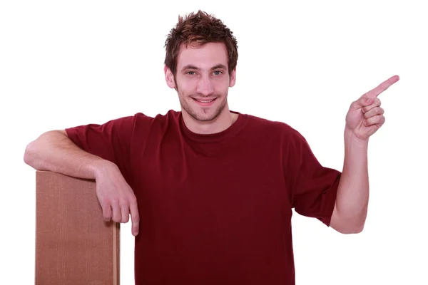 Handyman med golvbrädorna pekar till vänster — Stockfoto