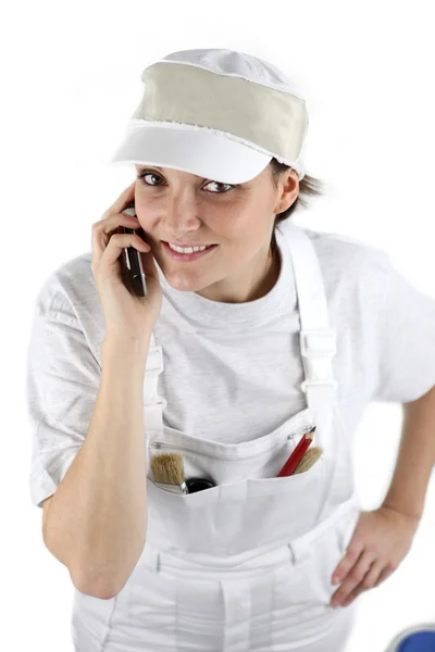 Female decorator contacting customer via telephone — Stock Photo, Image