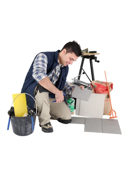 stock image Young tiler at work isolated against white