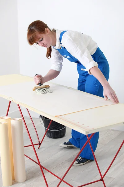 Woman pasting wall paper — Stock Photo, Image