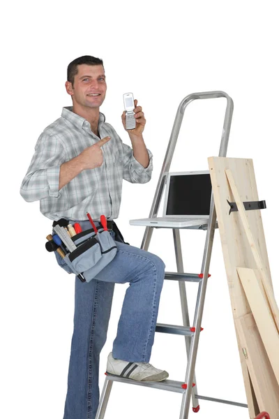 Carpenter posing by step-ladder — Stock Photo, Image