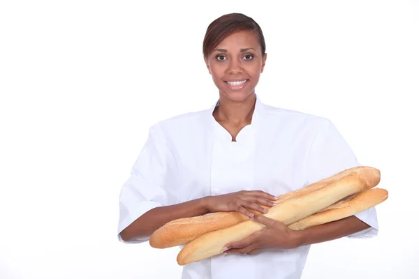 Woman with loaves of bread in the arms — Stock Photo, Image