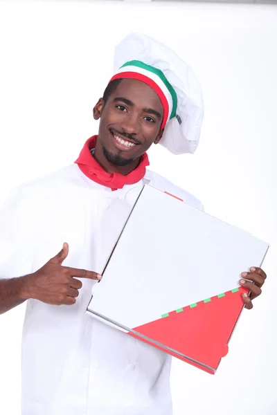 Chef italiano con temática apuntando a una caja de pizza para llevar —  Fotos de Stock