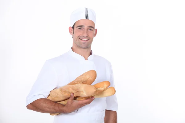 Baker with baguettes — Stock Photo, Image