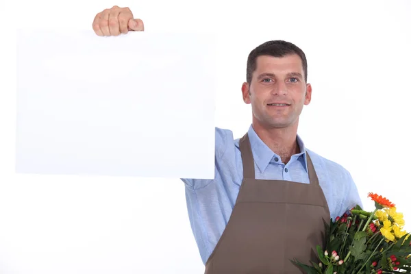 Florist som håller upp ett tomt tecken — Stockfoto