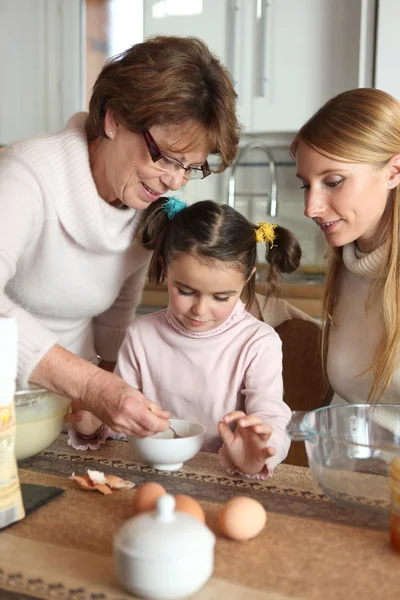 Bambina che prepara la torta con sua madre e sua nonna — Foto Stock