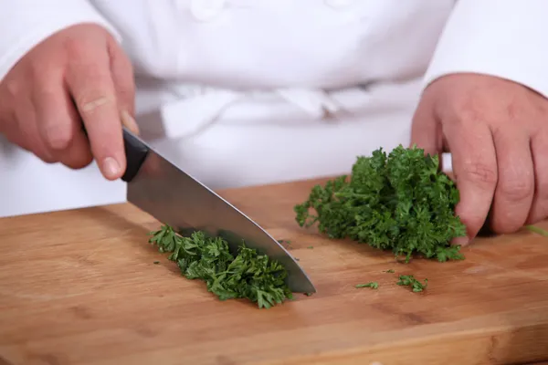Chef chopping parsley — Stock Photo, Image