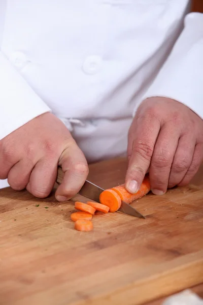 Mężczyzna szefa kuchni do krojenia marchewki — Zdjęcie stockowe