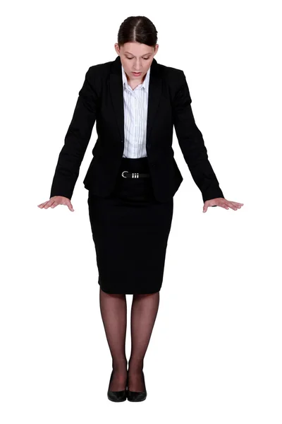 Businesswoman trying to keep her balance Stock Image