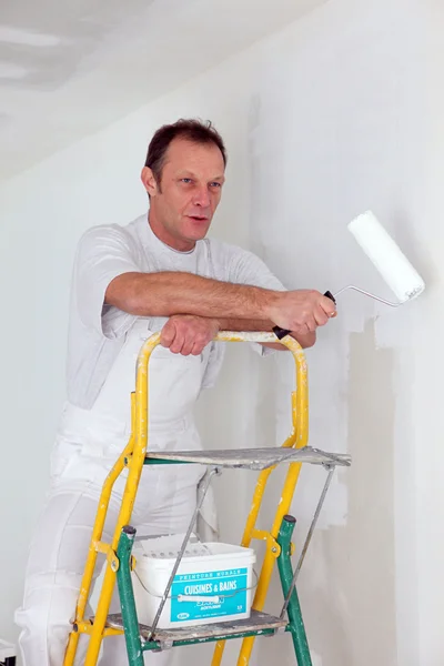 Man painting a wall Stock Picture