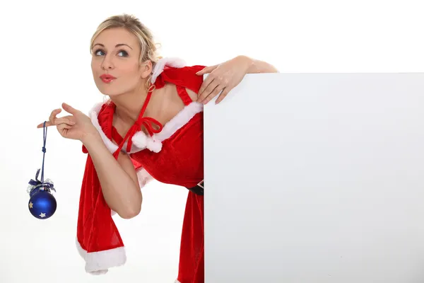 Woman dressed as Mrs. Claus and holding a blank board — Stock Photo, Image