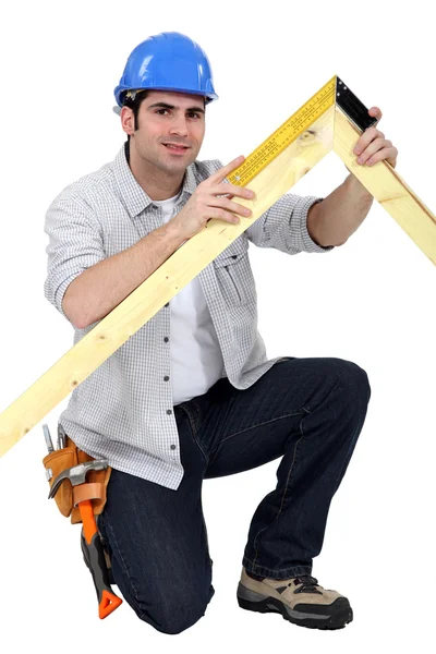 Carpenter with wood frame — Stock Photo, Image