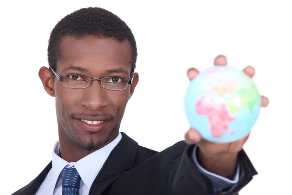 Businessman holding the world in the palm of his hand — Stock Photo, Image