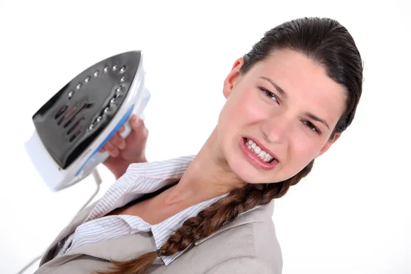 A businesswoman unhappy with her ironing. — Stock Photo, Image