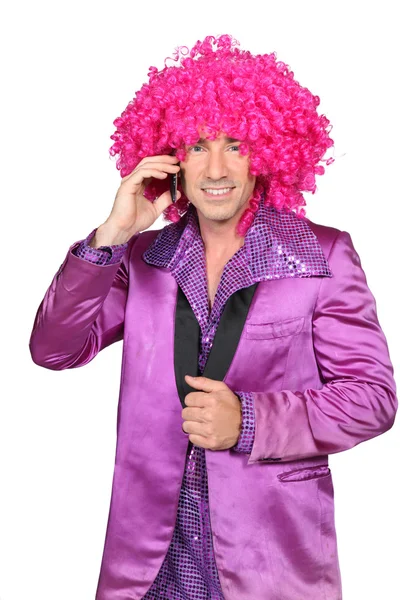 Man in Seventies costume and crazy wig on cellphone Stock Image